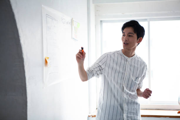 Young man giving a presentation at stylish office