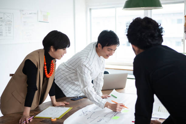 istock Casually dressed professionals having meeting around a table in a stylish office 1457254149