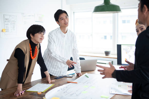 istock Casually dressed professionals having meeting around a table in a stylish office 1457254164