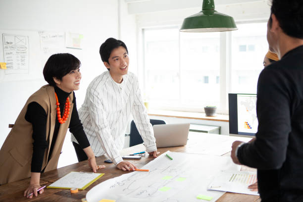 istock Casually dressed professionals having meeting around a table in a stylish office 1457254170