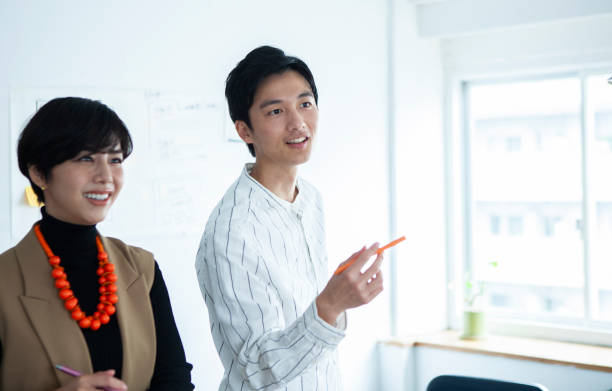 istock A young man leading a discussion in a company meeting. 1457254196