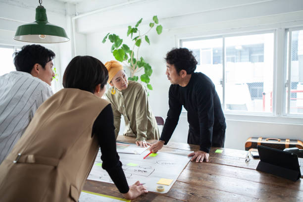 istock Casually dressed professionals having meeting around a table in a stylish office 1457254212