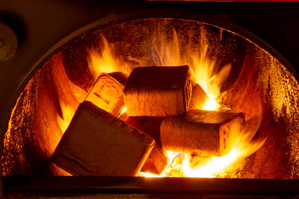 Wood briquettes (ruf type), made of beech and oak burning inside the wood fuel boiler. Alternative fuel, eco fuel, bio fuel. stock photo