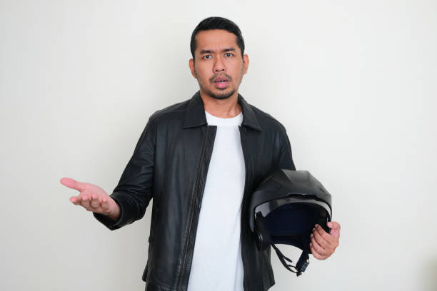 Man with his motorbike in streets