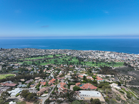Aerial view over La Jolla Hills with big villas and ocean in the background, San Diego, California, USA