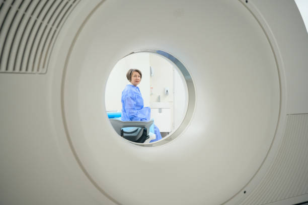 istock Elderly patient looks into the camera of a CT machine 1457266868