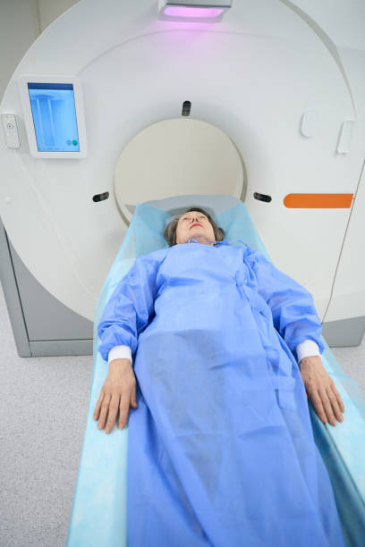 istock Patient lies on the mobile surface of the CT machine 1457266871