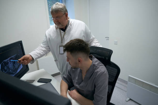istock Two doctors are analyzing MRI results in a diagnostic room 1457266906
