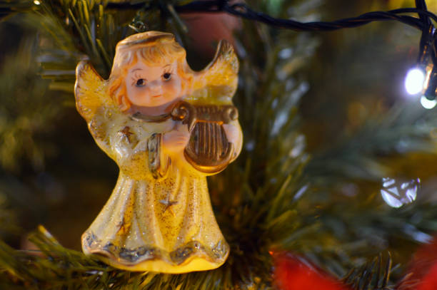 istock small angel figurine hanging on the Christmas tree close up 1457268808