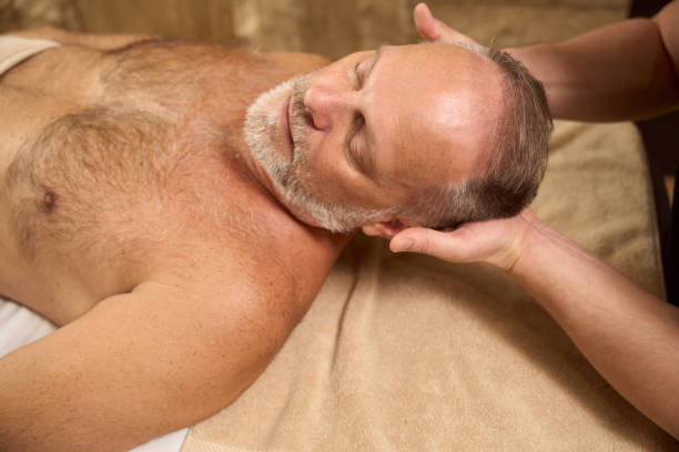 istock Physiotherapist supports the man head during manual manipulations 1457270044