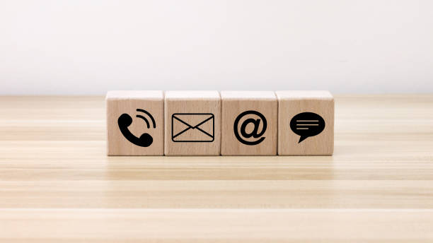 istock Website page contact us or e-mail marketing concept, Customer support hotline Contact us people connection. phone, email, address and chat message icon on wooden blocks 1457273379