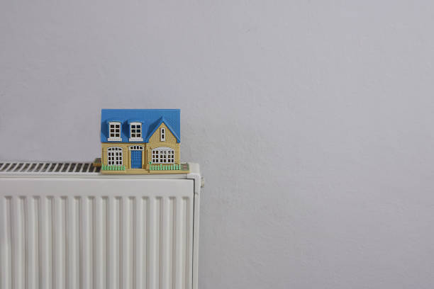 istock House model on radiator, Winter heating efficiency concept 1457275683