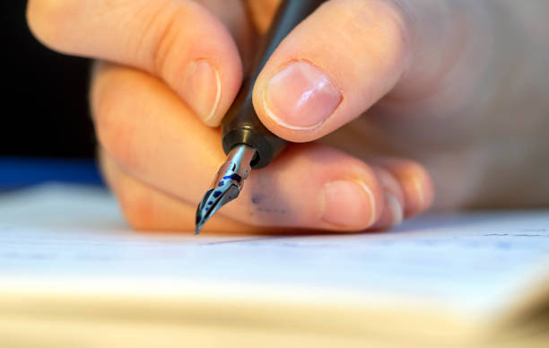 istock Hand with ink pen .Caligraphy concept 1457277407