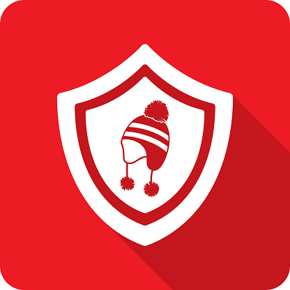 Vector illustration of a shield with snow hat icon against a red background in flat style.