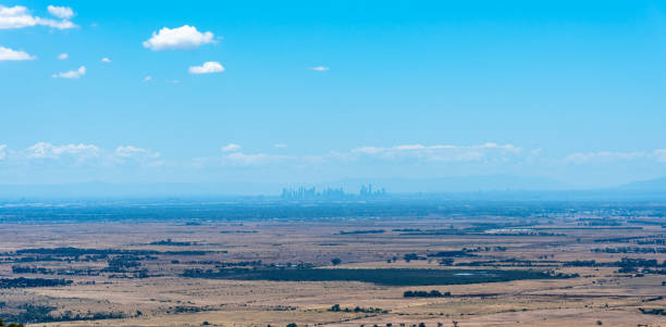 the city buildings of melbourne, australia in the distance, as seen from the top of the you yangs ranges - melbourne cityscape clear sky day imagens e fotografias de stock