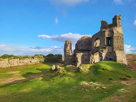 Pennard Castle was built in the early 12th century as a timber ringwork following the Norman invasion of Wales. It is located on the hill overlooking Three Cliffs Bay.