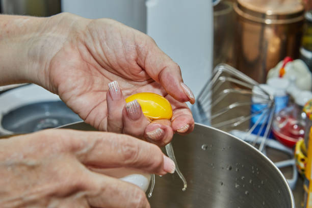 istock Chef separates the yolk from the protein to make the pie 1457282265