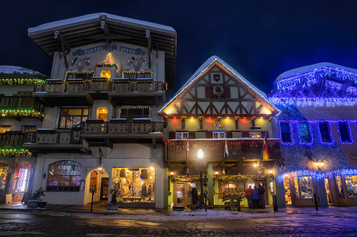 Street and buildings with Christmas lighting decoration at blue hour in Bavarian themed town of Leavenworth, Washington, USA