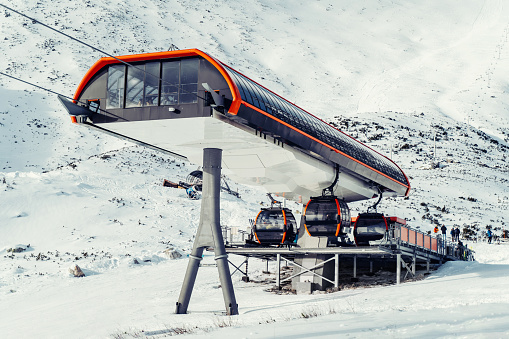 Modern funicular in the mountain at the ski resort with cabins