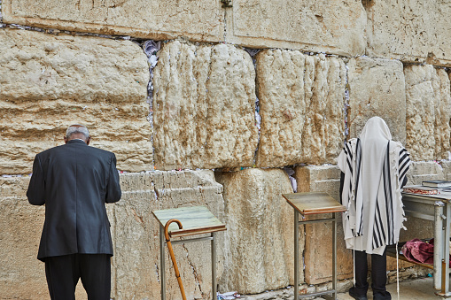 Jerusalem, Israel - November 15, 2022: View of the Wailing Wall with worshipers, the shrine of the Jewish religion in Jerusalem.