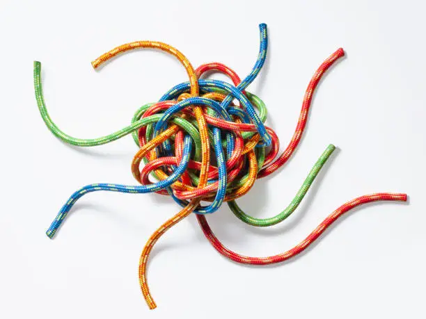 Photo of The concept of choice. Tangled colorful strings.