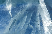 The pattern and texture of blue ice on the surface of a frozen lake