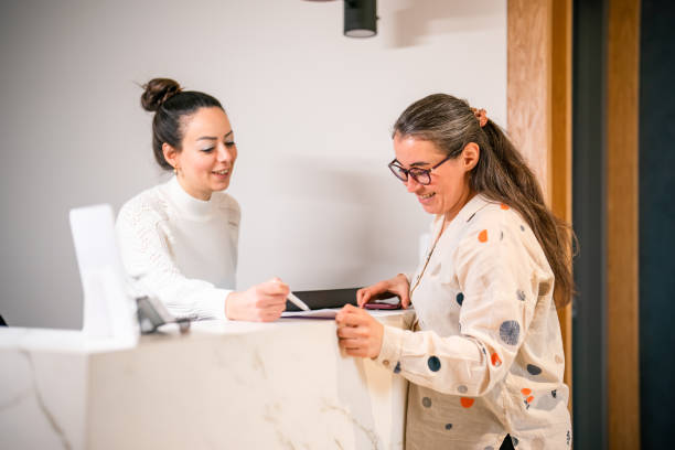 Female patient at the front desk, filling forms