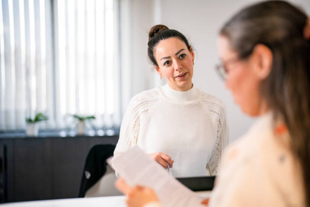 istock Female patient at the front desk, filling forms 1457289147