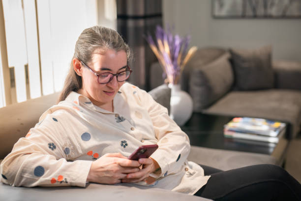 istock Woman using mobile phone at waiting room 1457289248