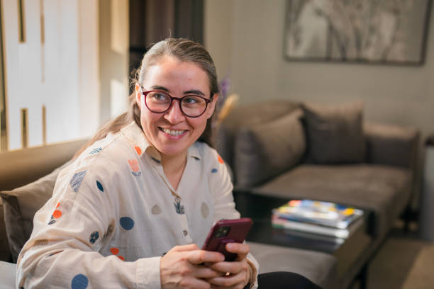 istock Woman using mobile phone at waiting room 1457289275