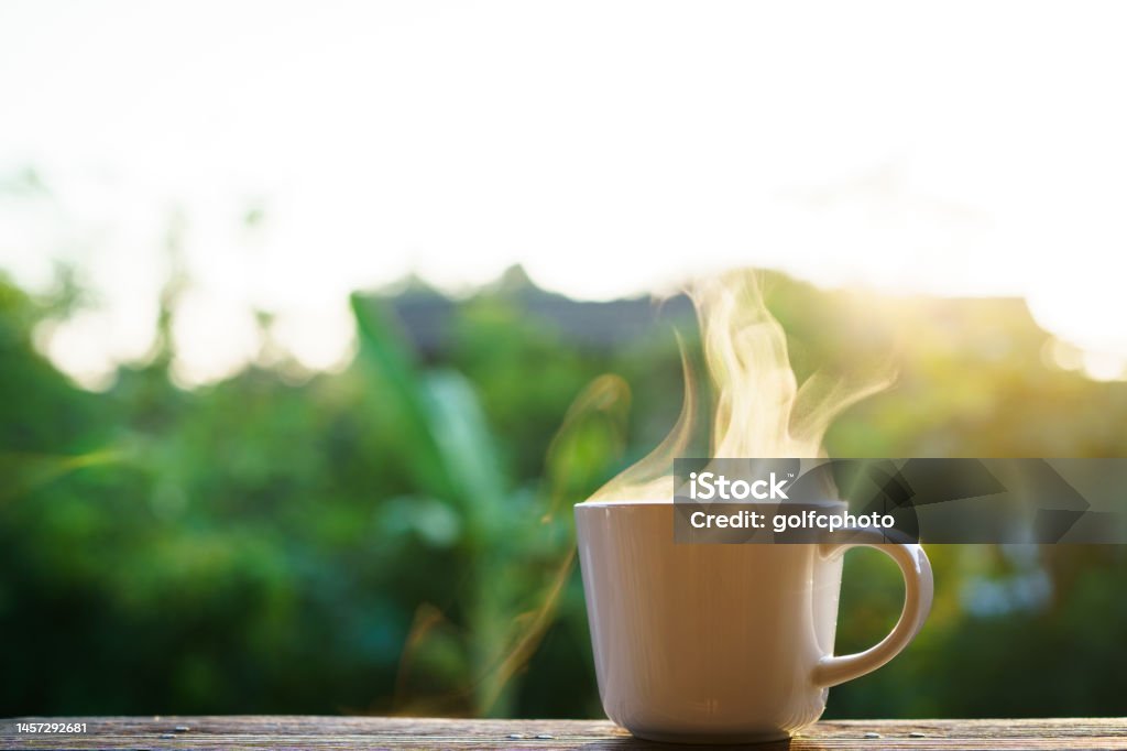 Espresso coffee in Moka Pot Beautiful sunrise lighting in the morning with a hot coffee and Moka Pot close up with copyspace. Beautiful natural sun lighting bokeh and coffee cup in the morning. Coffee - Drink Stock Photo
