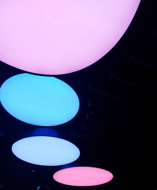 istock pink and blue circles on a black background 1457295559