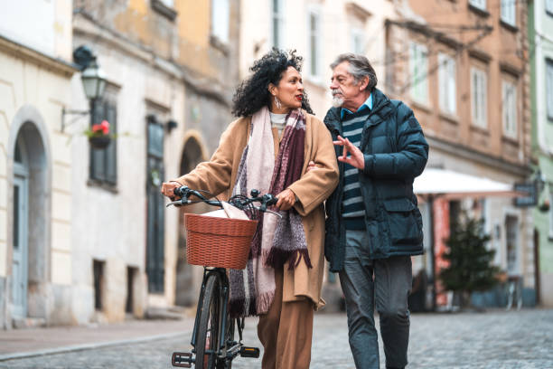 istock Mature Couple Talking while Walking in the Empty City Streets 1457297639