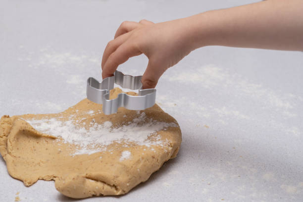 istock children's hands making cookie shapes with the help of cookie cutters. 1457297787