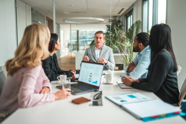 istock Handsome Caucasian Businessman Making Presentation to Team 1457297916