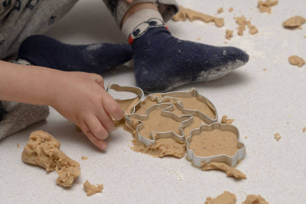 istock child's hand placing a mold to make cookies 1457298042