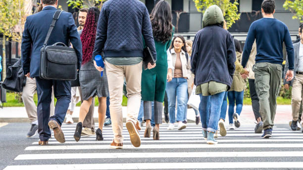 istock Diverse people crossing crosswalk at daytime 1457298160