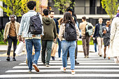 Citizens crossing crowded zebra, wide shot