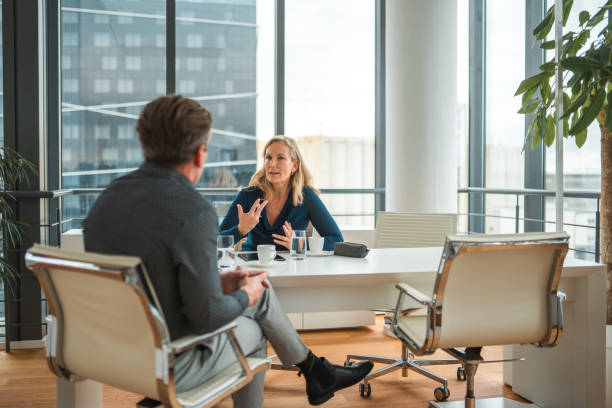 Caucasian Female Executive Interviewing a Job Candidate in Business District stock photo