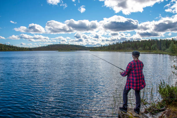 istock Woman fishing 1457301728