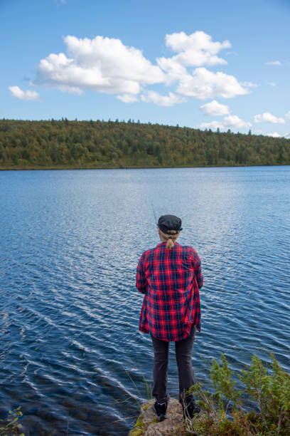 istock Woman fishing 1457301921