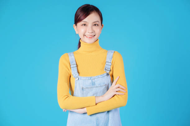 istock Young Asian girl posing on blue background 1457305674
