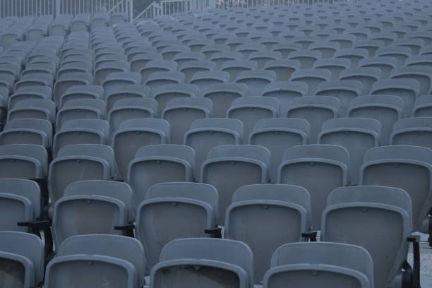 istock Tribune sports stadium, gray chairs arranged in rows 1457306822