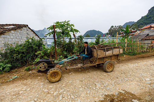 Bac Son, Long Son, Vietnam - November 21, 2019: A farmer with his tractor in Vietnam