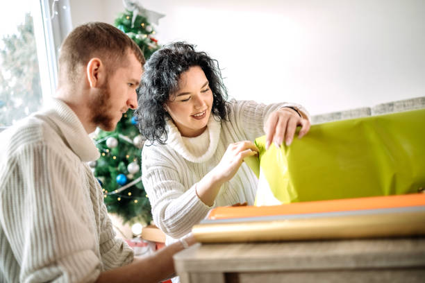 istock Young couple packing gifts for Christmas 1457312963