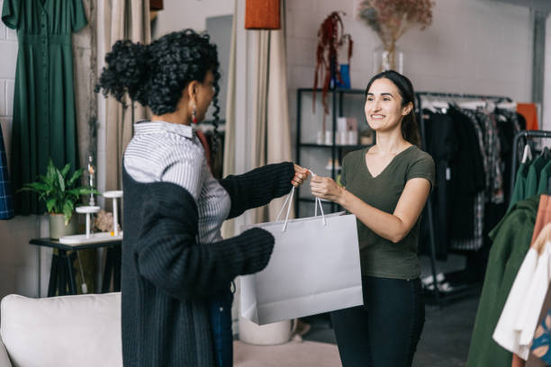 istock Happy customer receiving her purchased clothes 1457314895