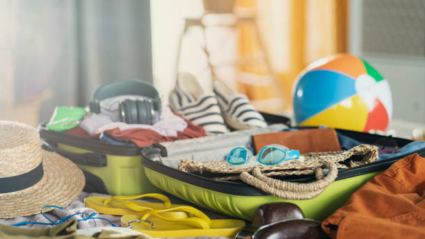 istock Preparation travel suitcase at home 1457315882