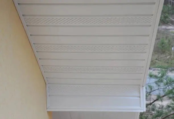 Photo of Plastic white uPVC soffit board below the facia of the roof.