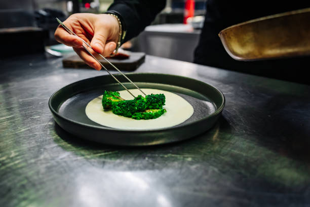 istock chef hand cooking broccoli with cheese sauce on restaurant kitchen 1457325128