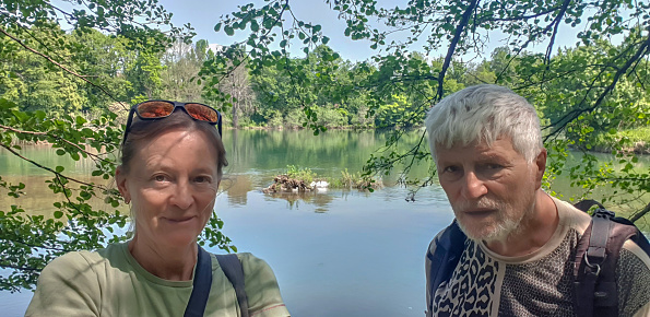 Mature women and men relaxing in natural close to the river Krka